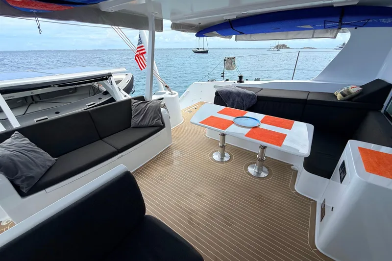 Slide: The Image of Luxurious 2021 Balance 526 yacht deck with seating, table, and ocean view. - 7