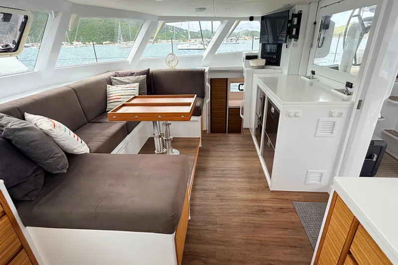 Slide: The Image of Modern yacht interior with cozy seating, wooden flooring, and large windows overlooking the sea. Balance 526, 2021. - 9