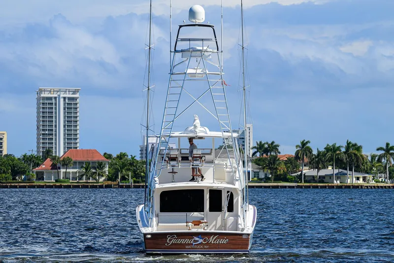 Slide: The Image of 2007 Viking 56 Convertible yacht on water, cityscape and palm trees in background. - 10