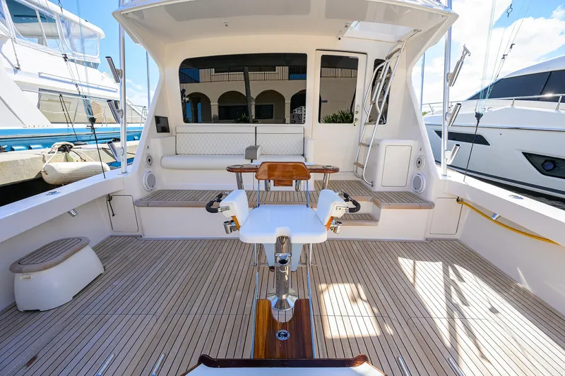 Slide: The Image of 2007 Viking 56 Convertible yacht cockpit with seating, fishing chair, and teak flooring. - 15