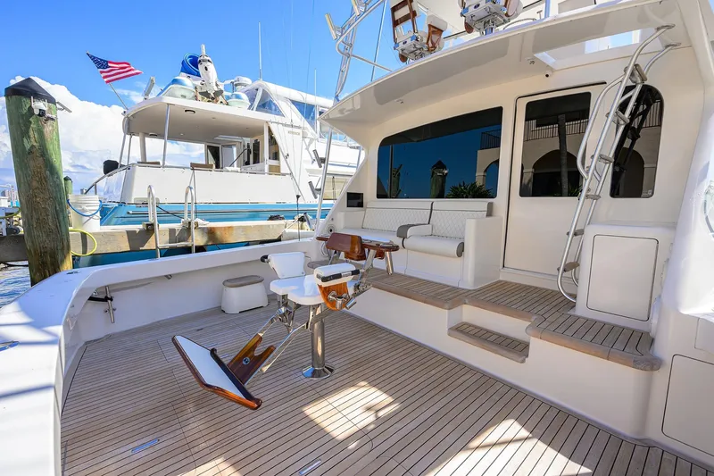 Slide: The Image of 2007 Viking 56 Convertible yacht with spacious deck and seating area at marina. - 16