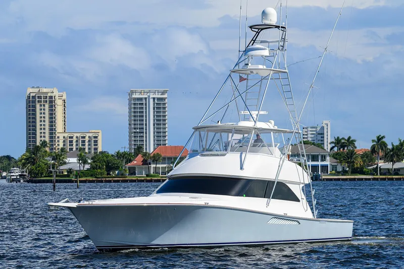 Slide: The Image of 2007 Viking 56 Convertible yacht cruising near waterfront cityscape. - 2