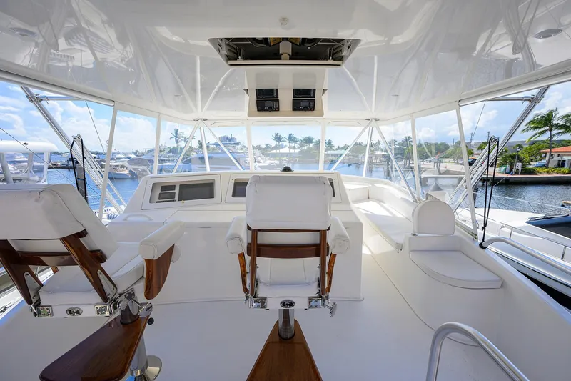 Slide: The Image of Interior view of 2007 Viking 56 Convertible yacht's helm with luxurious seating and panoramic windows. - 21