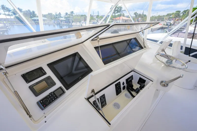 Slide: The Image of 2007 Viking 56 Convertible yacht helm with advanced navigation and control systems. - 23