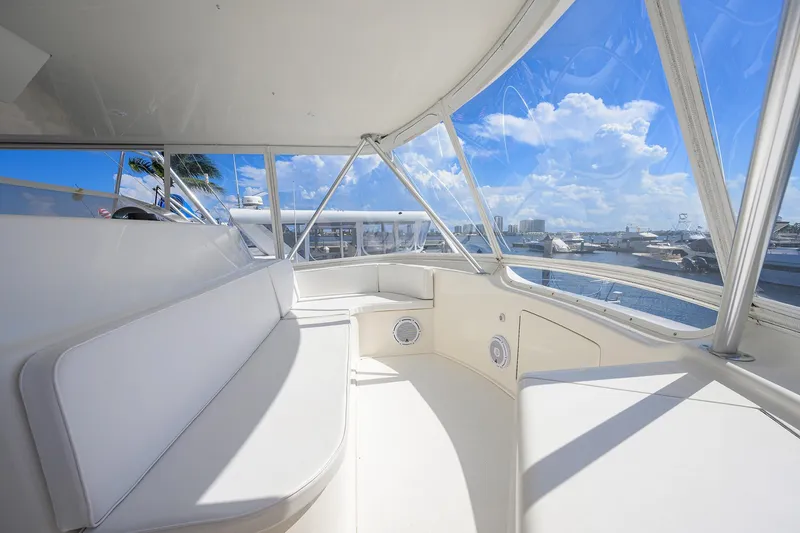Slide: The Image of Interior view of 2007 Viking 56 Convertible yacht with white seating and ocean backdrop. - 24
