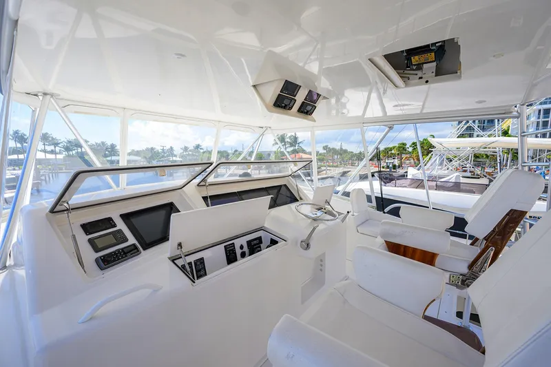Slide: The Image of 2007 Viking 56 Convertible yacht cockpit with modern navigation equipment and white seating. - 26