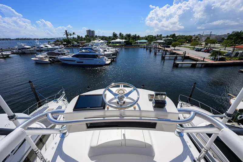 Slide: The Image of View from 2007 Viking 56 Convertible yacht helm overlooking marina with boats and clear sky. - 32
