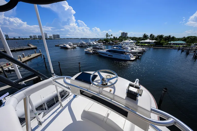 Slide: The Image of View from 2007 Viking 56 Convertible yacht overlooking marina with boats and clear blue sky. - 34