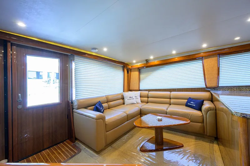Slide: The Image of Luxurious interior of 2007 Viking 56 Convertible yacht with leather seating and wooden accents. - 39