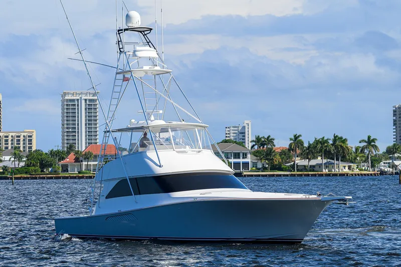 Slide: The Image of 2007 Viking 56 Convertible yacht cruising near waterfront cityscape. - 4