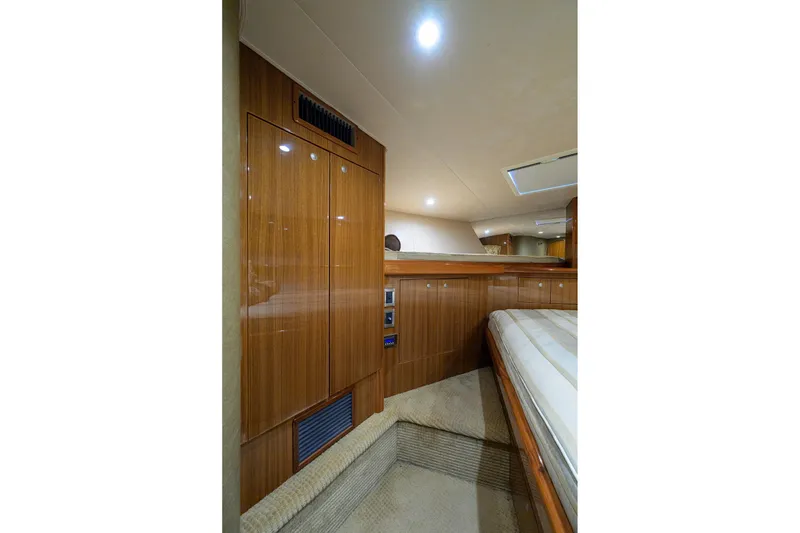 Slide: The Image of Luxurious interior of 2007 Viking 56 Convertible yacht with wood paneling and cozy lighting. - 42