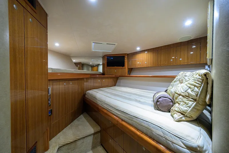 Slide: The Image of Luxurious cabin interior of 2007 Viking 56 Convertible yacht with wood finish and cozy bedding. - 49