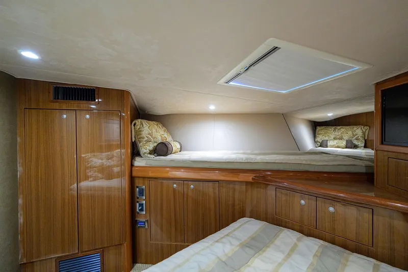 Slide: The Image of Luxurious cabin interior of 2007 Viking 56 Convertible yacht with wooden finishes and cozy bedding. - 50
