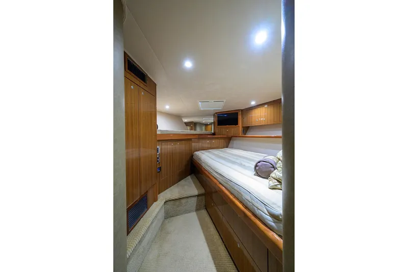 Slide: The Image of Luxurious cabin interior of 2007 Viking 56 Convertible yacht with wood paneling and cozy bedding. - 51