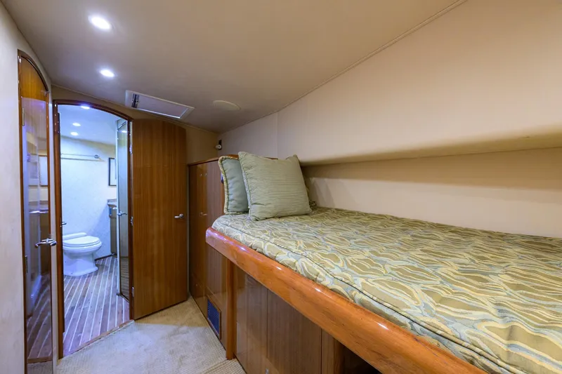 Slide: The Image of 2007 Viking 56 Convertible yacht interior with cozy bed and ensuite bathroom. - 53