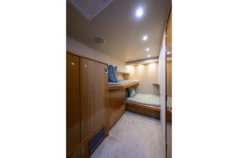 Slide: The Image of Interior cabin of 2007 Viking 56 Convertible yacht with bunk beds and wooden cabinetry. - 54