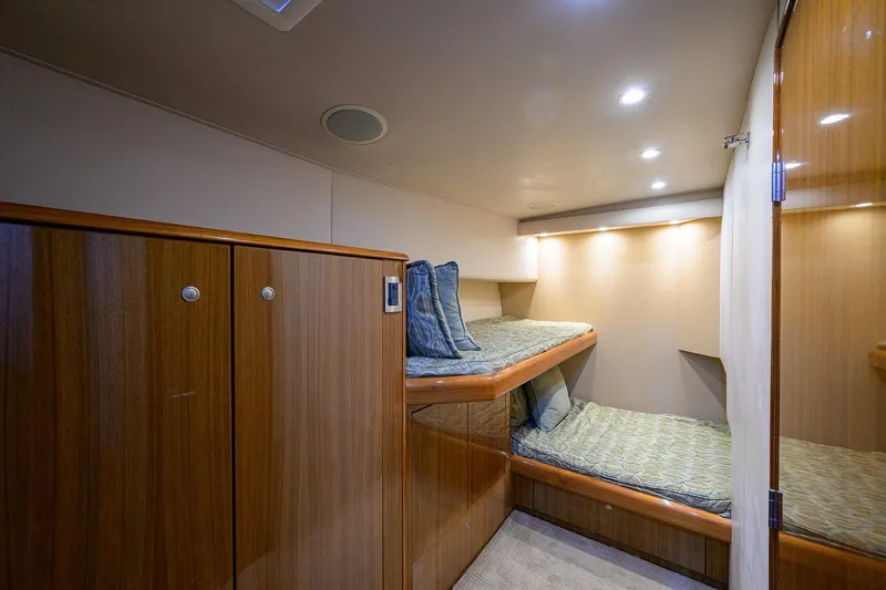 Slide: The Image of Interior cabin of 2007 Viking 56 Convertible yacht with bunk beds and wooden cabinetry. - 55