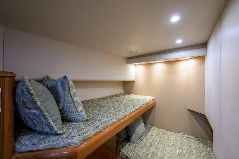 Slide: The Image of Cozy cabin interior of 2007 Viking 56 Convertible yacht with bunk beds and soft lighting. - 56