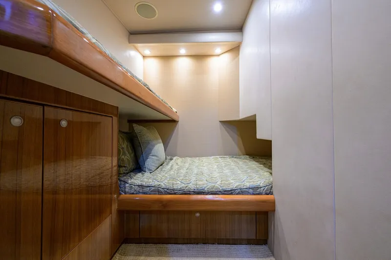 Slide: The Image of Cozy cabin interior of 2007 Viking 56 Convertible yacht with bunk beds and wooden cabinetry. - 57