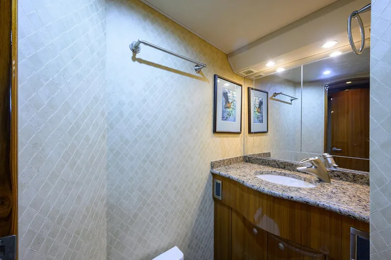 Slide: The Image of Luxurious bathroom in 2007 Viking 56 Convertible yacht with granite countertop and elegant decor. - 59