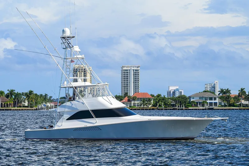 Slide: The Image of 2007 Viking 56 Convertible yacht cruising near waterfront cityscape. - 6