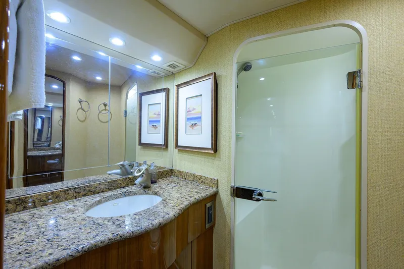 Slide: The Image of Luxurious bathroom in 2007 Viking 56 Convertible yacht with granite countertop and glass shower. - 61