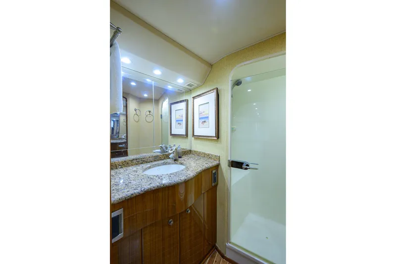 Slide: The Image of Luxurious bathroom in 2007 Viking 56 Convertible yacht with granite countertop and glass shower. - 63