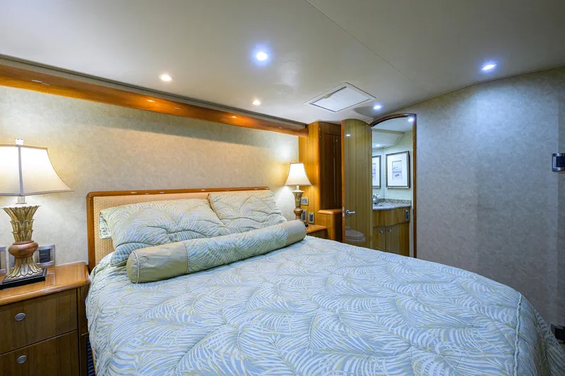 Slide: The Image of Luxurious bedroom interior of 2007 Viking 56 Convertible yacht with elegant bedding and lighting. - 64