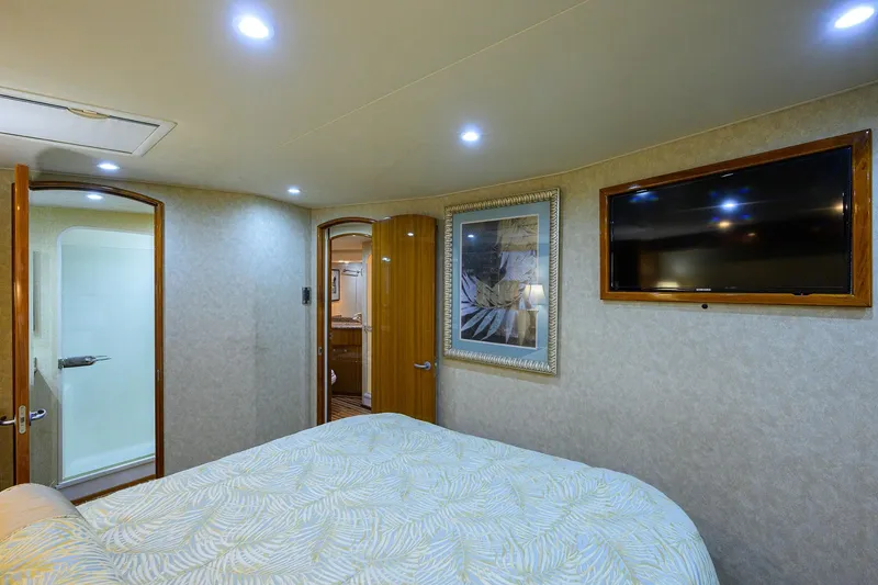 Slide: The Image of Luxurious bedroom interior of 2007 Viking 56 Convertible yacht with TV and ensuite bathroom. - 67