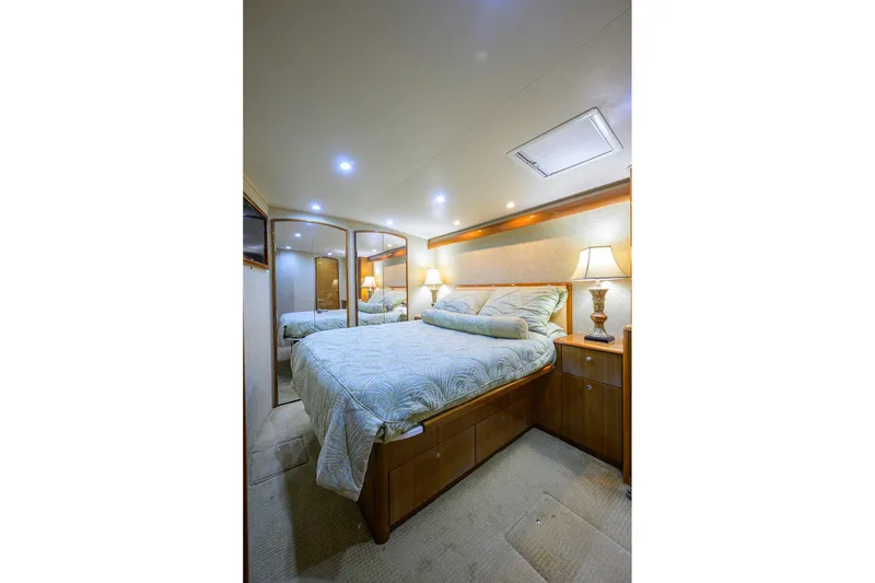 Slide: The Image of Luxurious bedroom interior of 2007 Viking 56 Convertible yacht with elegant bedding and warm lighting. - 68