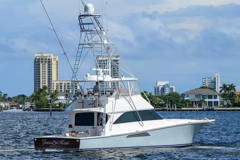 Slide: The Image of 2007 Viking 56 Convertible yacht cruising near waterfront cityscape. - 7