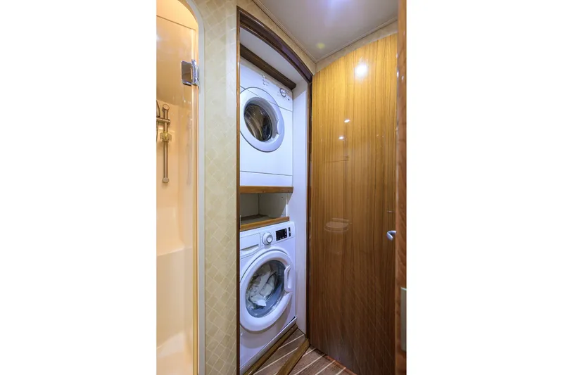 Slide: The Image of Laundry area in 2007 Viking 56 Convertible yacht with stacked washer and dryer. - 70