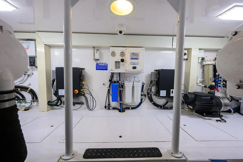 Slide: The Image of Engine room of a 2007 Viking 56 Convertible yacht, featuring equipment and control panels. - 75