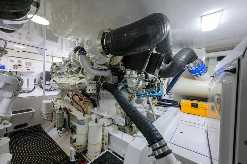 Slide: The Image of Engine room of 2007 Viking 56 Convertible yacht, showcasing complex machinery and components. - 76
