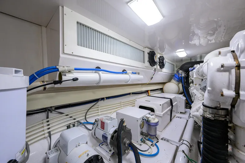 Slide: The Image of Engine room of a 2007 Viking 56 Convertible yacht, showcasing mechanical components and piping. - 79