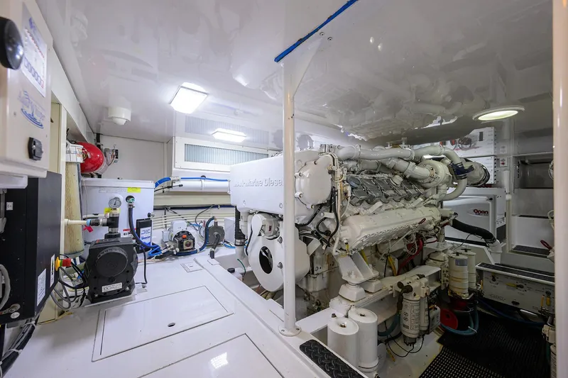 Slide: The Image of Engine room of a 2007 Viking 56 Convertible yacht, showcasing marine diesel engine and equipment. - 81