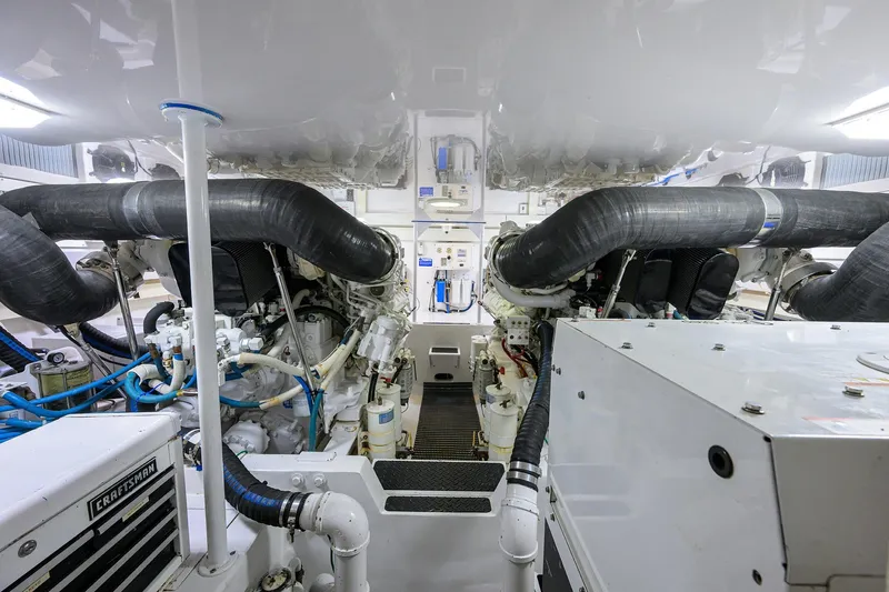 Slide: The Image of Engine room of a 2007 Viking 56 Convertible yacht, showcasing dual engines and mechanical systems. - 84