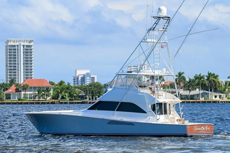 Slide: The Image of 2007 Viking 56 Convertible yacht cruising near waterfront buildings and palm trees. - 9