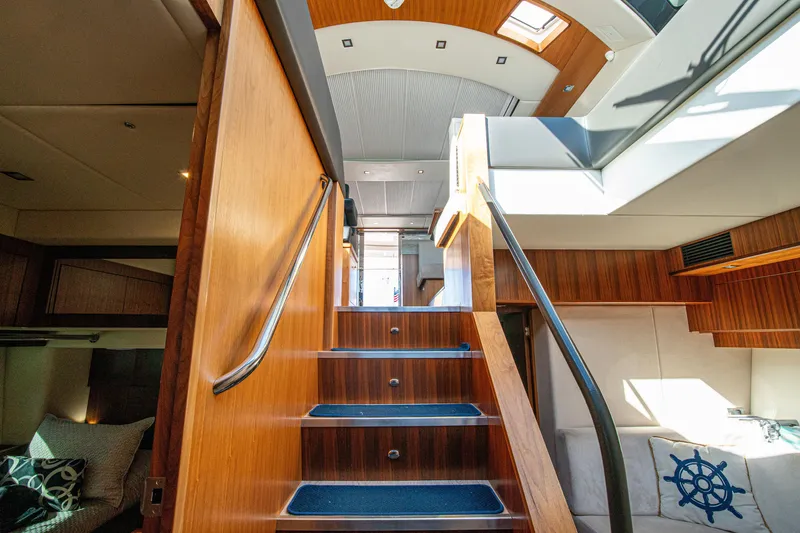 Slide: The Image of Interior view of 2015 Riviera 6000 Sport Yacht with wooden stairs and modern design. - 40