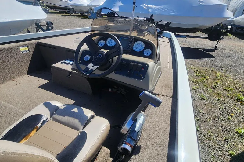 Slide: The Image of 2008 Triton VT 19 boat interior with steering wheel and control panel. - 2