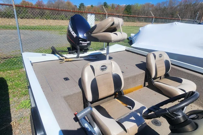 Slide: The Image of 2008 Triton VT 19 boat interior with Evinrude motor and beige seating. - 9