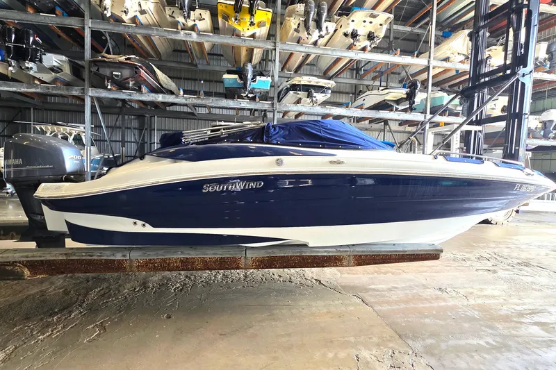 The Image of 2012 SouthWind 2400 SD boat in storage, blue and white hull, indoor facility. - 0