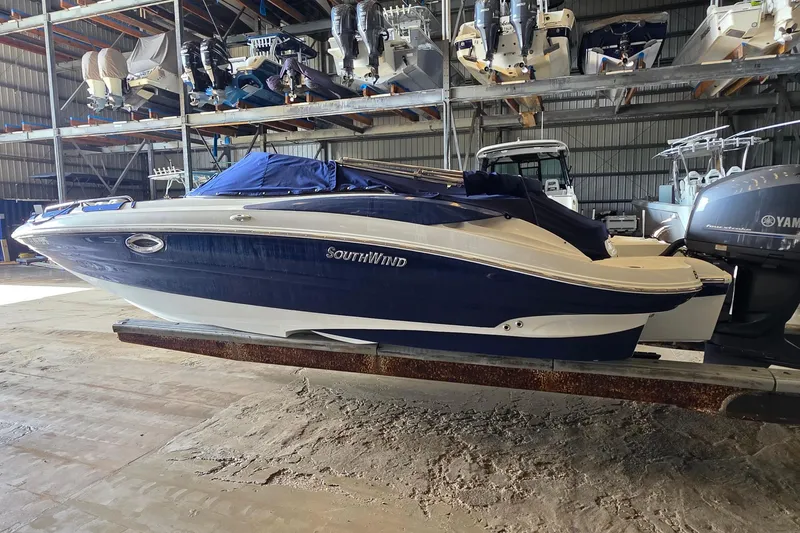 Slide: The Image of 2012 SouthWind 2400 SD boat in storage, covered and elevated, with Yamaha engine. - 10