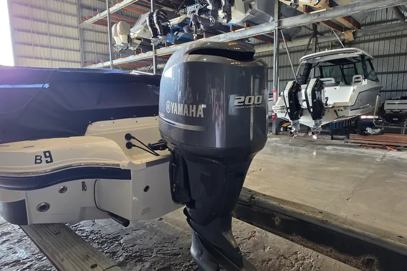 Slide: The Image of 2012 SouthWind 2400 SD boat with Yamaha 200 outboard motor in storage facility. - 13