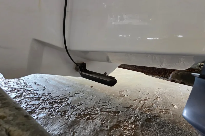 Slide: The Image of 2012 SouthWind 2400 SD boat hull with mounted transducer on a textured surface. - 14
