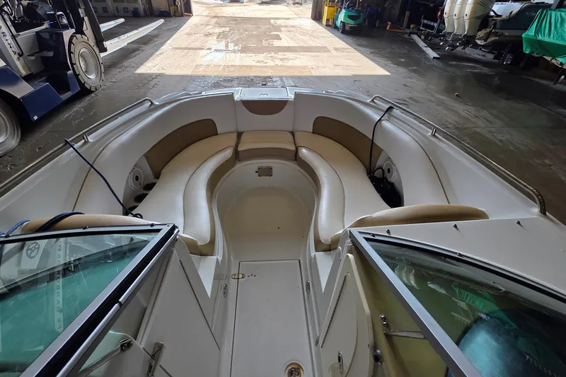 Slide: The Image of 2012 SouthWind 2400 SD boat interior with beige seating in a warehouse setting. - 19