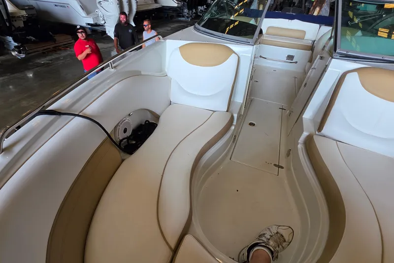 Slide: The Image of 2012 SouthWind 2400 SD boat interior with beige seating in a showroom. - 21