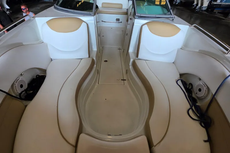 Slide: The Image of 2012 SouthWind 2400 SD boat interior with beige seating and storage compartments. - 22
