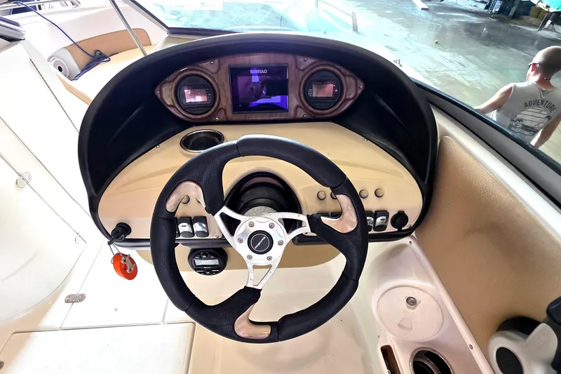Slide: The Image of Steering console of a 2012 SouthWind 2400 SD boat with modern controls. - 24