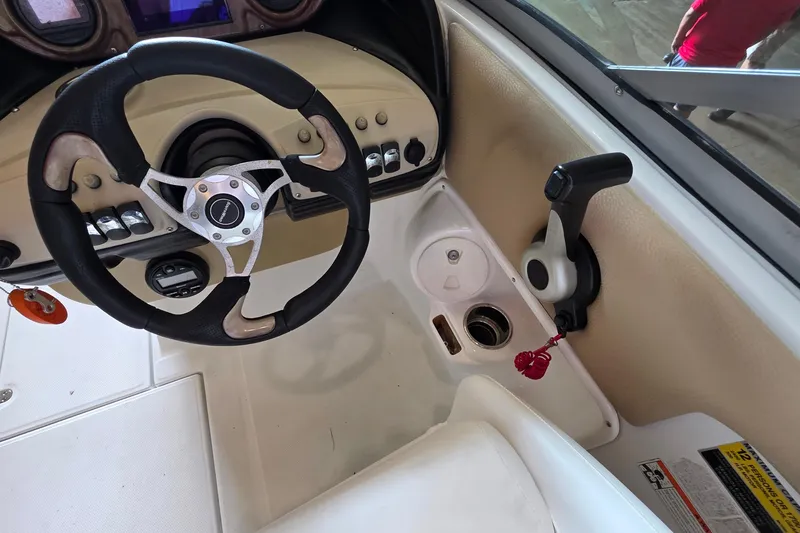 Slide: The Image of Steering wheel and controls of a 2012 SouthWind 2400 SD boat cockpit. - 25